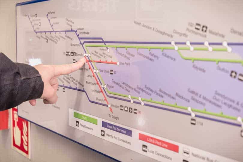 Woman pointing to destination on DART train map