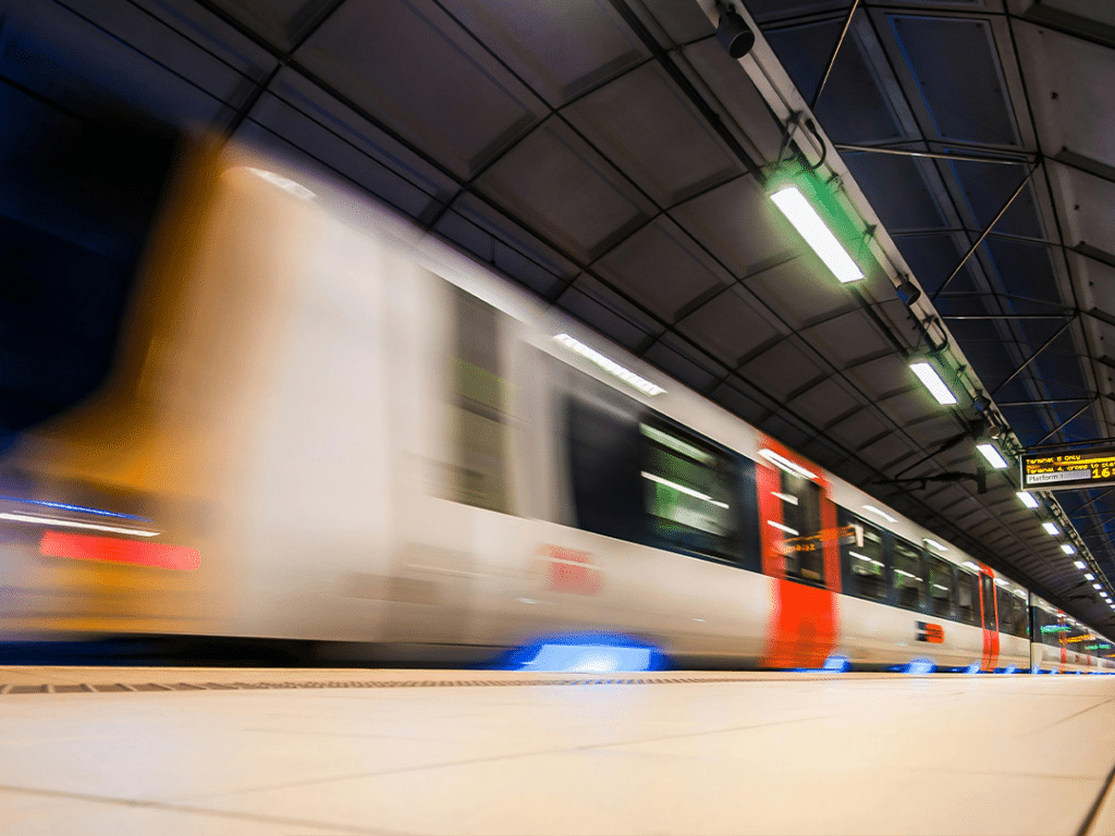 Train travelling through platform at speed